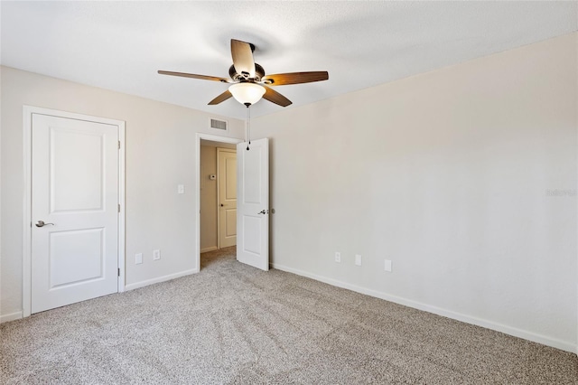 unfurnished bedroom with carpet, visible vents, ceiling fan, and baseboards