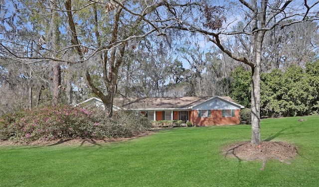 single story home with a front lawn and brick siding