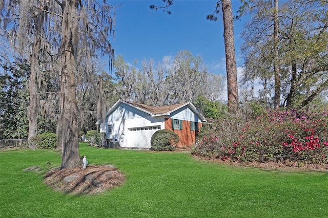 view of front of property with a garage and a front lawn