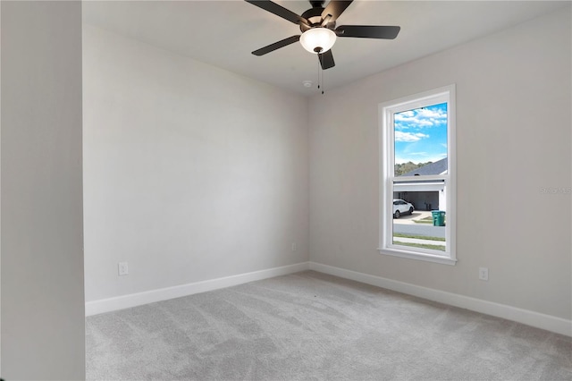 spare room featuring a ceiling fan, baseboards, and carpet flooring