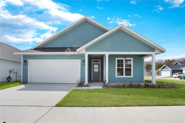 view of front of home with a garage, concrete driveway, and a front lawn