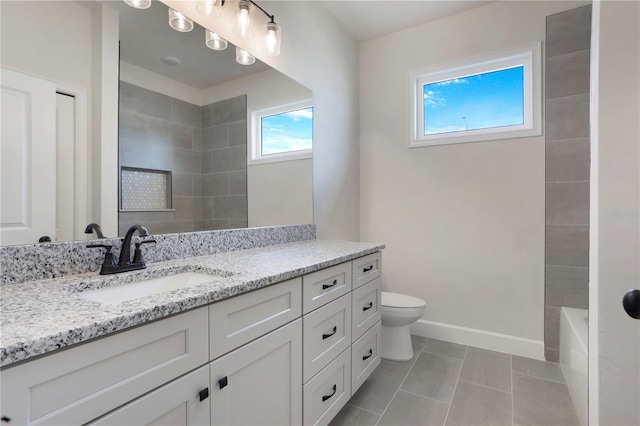 bathroom featuring toilet, tile patterned floors, vanity, and baseboards