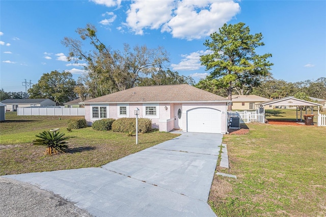 ranch-style home with stucco siding, concrete driveway, fence, cooling unit, and a front lawn