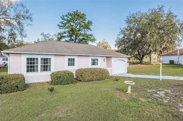 view of front of property with driveway, a front lawn, and stucco siding