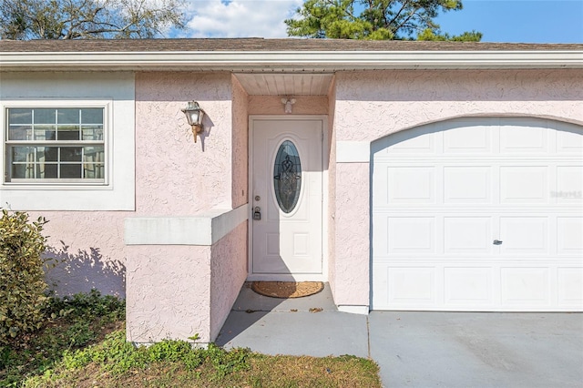 entrance to property featuring stucco siding