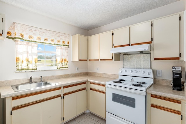 kitchen featuring white electric range oven, a textured ceiling, under cabinet range hood, a sink, and light tile patterned flooring