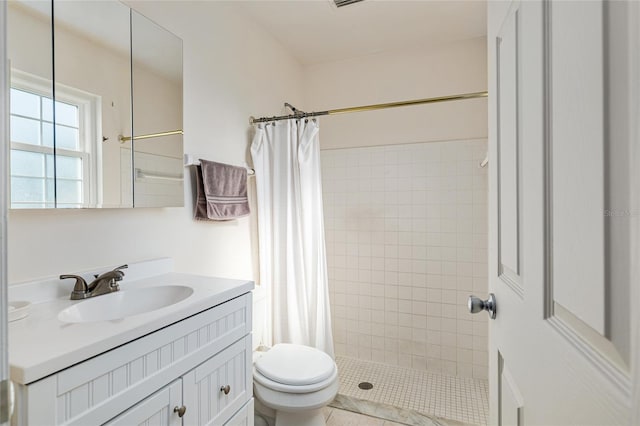 bathroom featuring toilet, a stall shower, and vanity