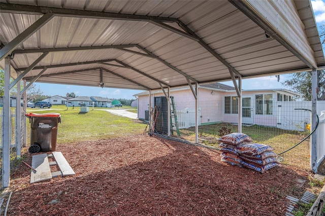 view of yard featuring a carport, a residential view, and fence