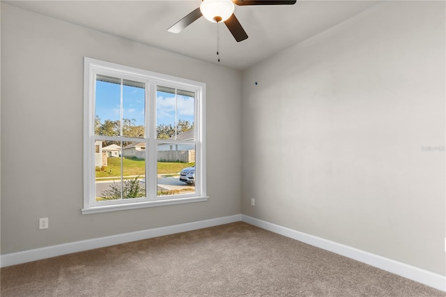 unfurnished room with carpet, baseboards, and a ceiling fan