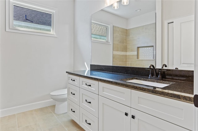 full bathroom with toilet, tile patterned floors, baseboards, and vanity