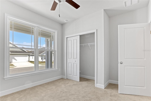 unfurnished bedroom featuring a closet, carpet flooring, visible vents, and baseboards