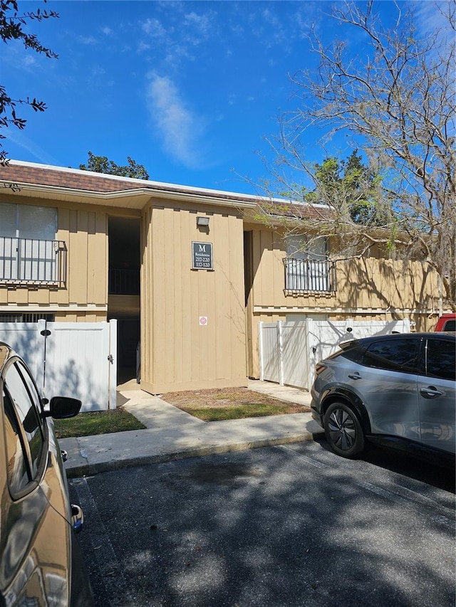 view of side of property with uncovered parking