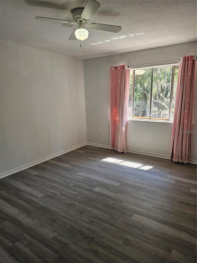 unfurnished room featuring dark wood-style floors, ceiling fan, a textured ceiling, and baseboards