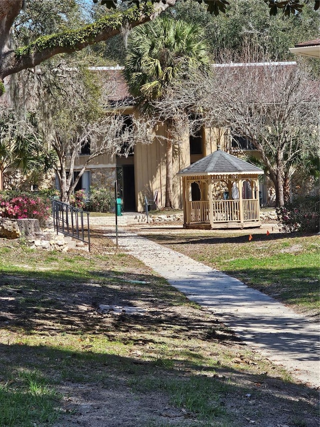 view of front of home featuring a gazebo and stone siding