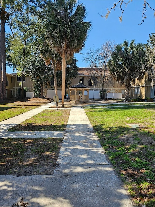 view of front of home with a gazebo and a front lawn