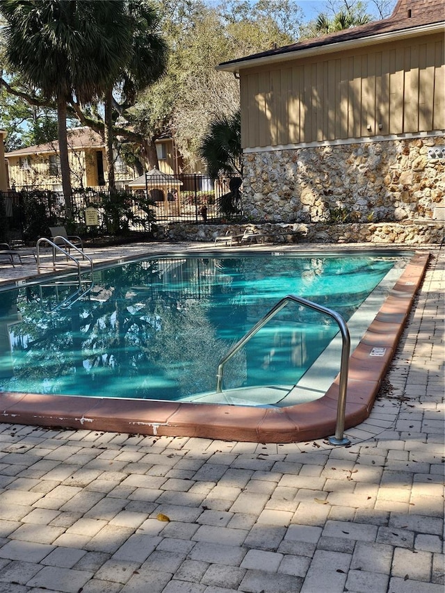 view of pool featuring a fenced in pool, fence, and a patio