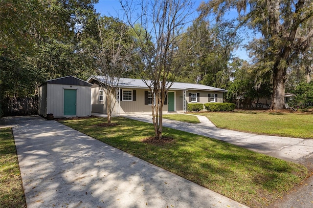 view of front of house featuring a front lawn, concrete driveway, and an outdoor structure