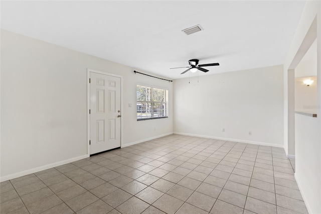 unfurnished room with ceiling fan, visible vents, and baseboards