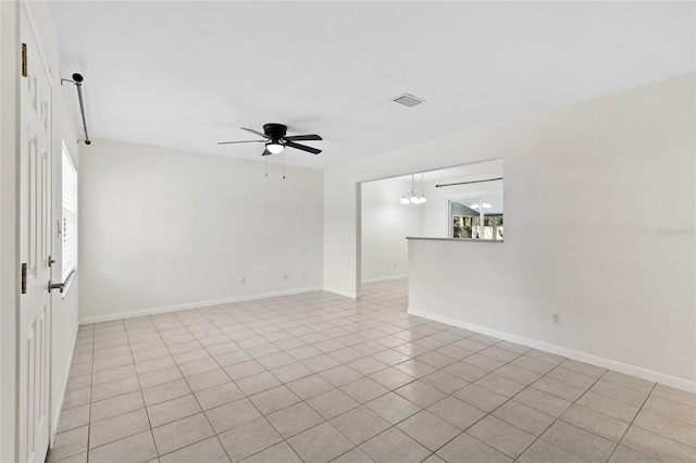 unfurnished room featuring visible vents, baseboards, and ceiling fan with notable chandelier