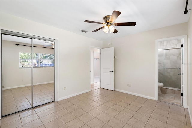 unfurnished bedroom with light tile patterned floors, ceiling fan, visible vents, baseboards, and a closet