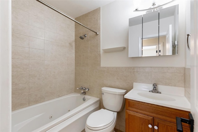 bathroom featuring tile walls, a combined bath / shower with jetted tub, vanity, and toilet