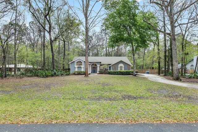 single story home featuring driveway and a front yard