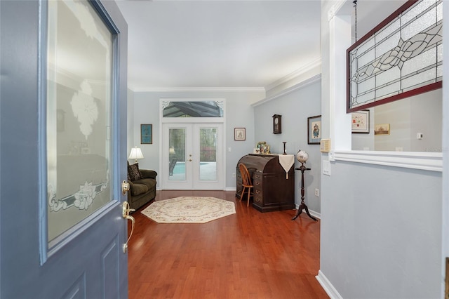 entryway with ornamental molding, french doors, baseboards, and wood finished floors