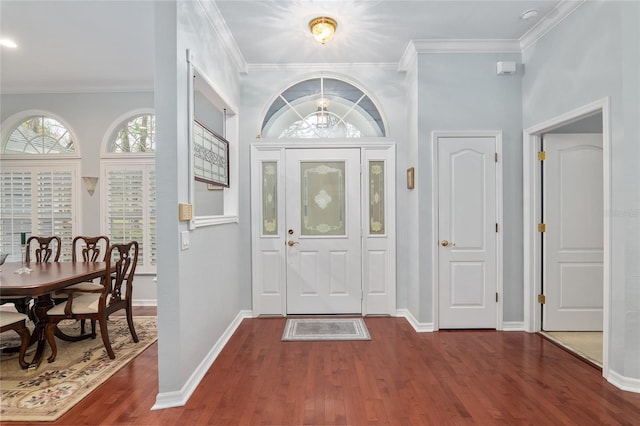 entrance foyer with crown molding, baseboards, and wood finished floors