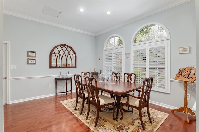 dining area featuring ornamental molding, recessed lighting, wood finished floors, and baseboards