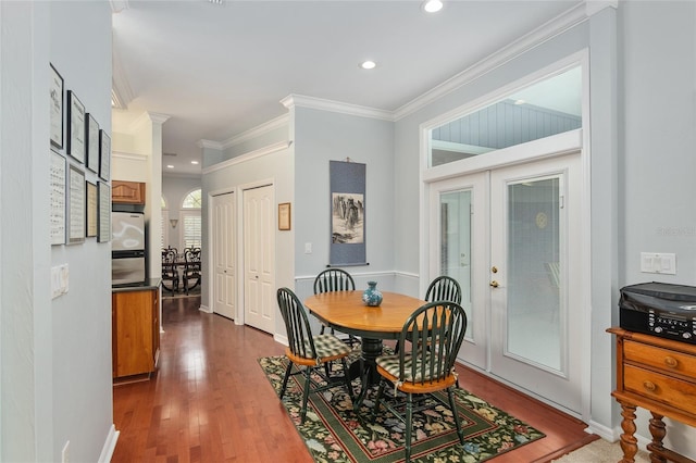 dining area featuring dark wood-type flooring, recessed lighting, french doors, and crown molding