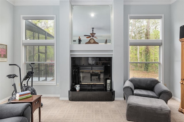 carpeted living room with ornamental molding, a fireplace, and a wealth of natural light