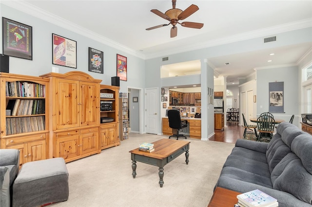 living room with ceiling fan, visible vents, and ornamental molding