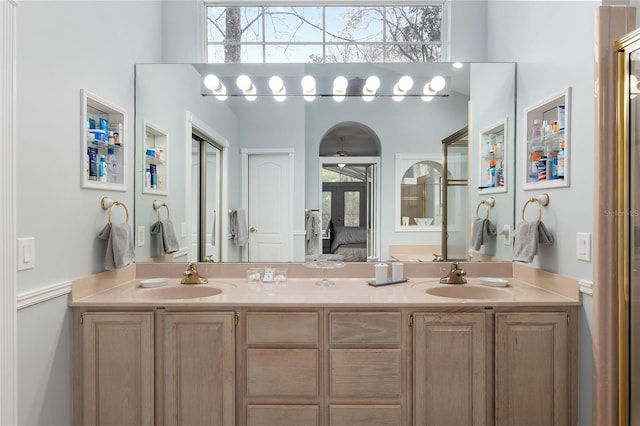 bathroom featuring double vanity, a sink, and connected bathroom