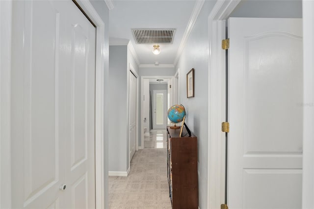 corridor featuring baseboards, visible vents, and crown molding