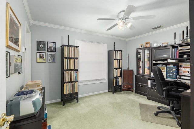 carpeted home office featuring ceiling fan, ornamental molding, visible vents, and baseboards