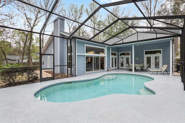 pool featuring french doors, a patio area, and a lanai