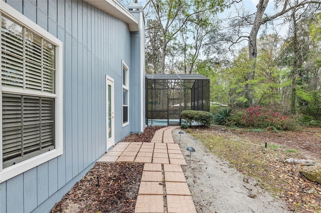 view of property exterior featuring glass enclosure