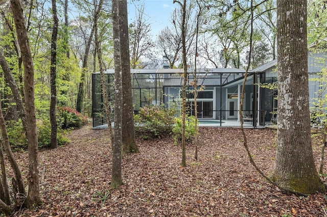 back of house featuring a patio, a lanai, and an outdoor pool