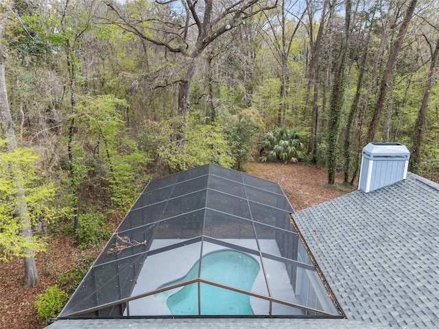 exterior details with a swimming pool and a forest view