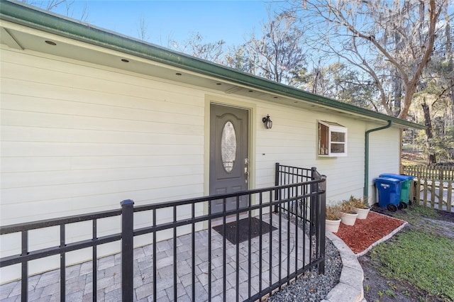 doorway to property with fence