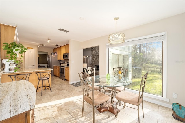 dining space featuring baseboards and visible vents