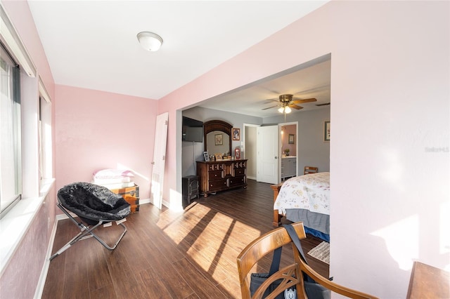 bedroom featuring a ceiling fan, baseboards, and wood finished floors