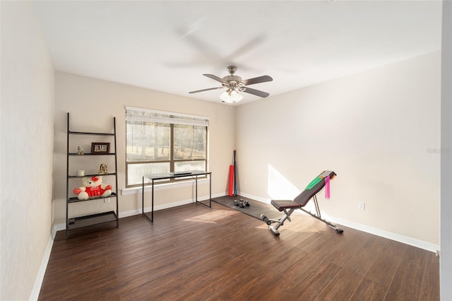 exercise area with baseboards and wood finished floors