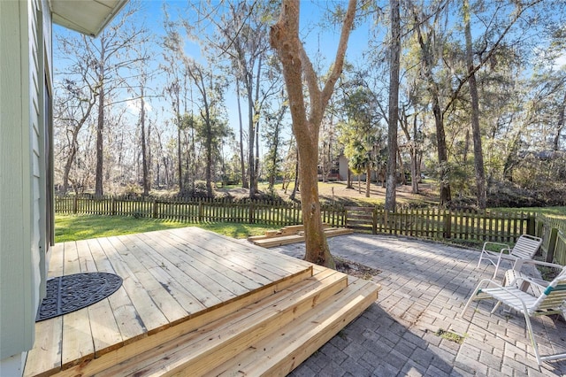 wooden terrace with fence and a patio