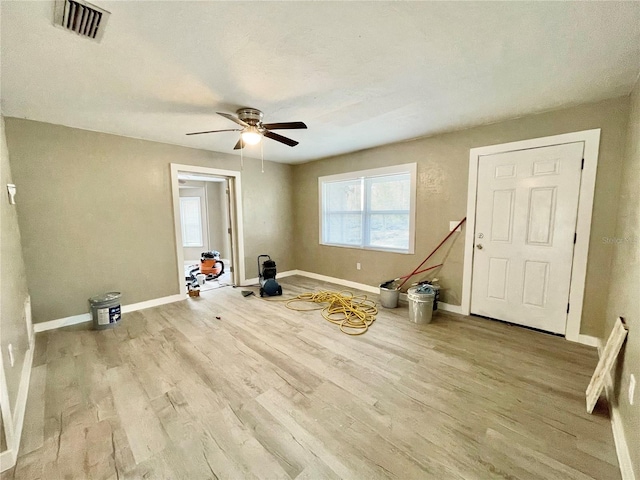 interior space featuring visible vents, ceiling fan, baseboards, and wood finished floors