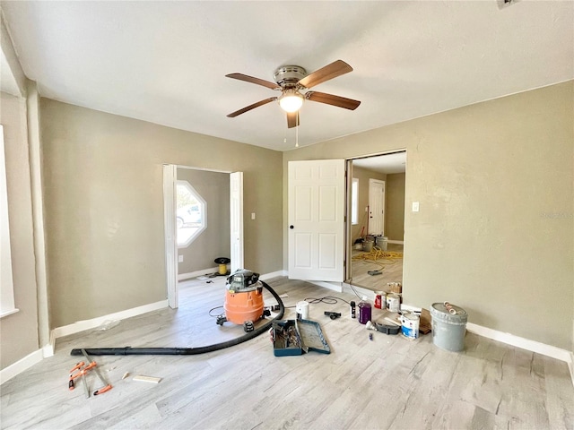 spare room featuring ceiling fan, baseboards, and wood finished floors