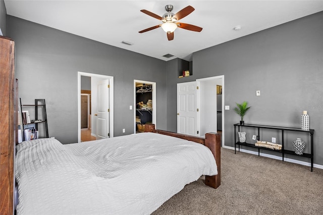 carpeted bedroom featuring a spacious closet, a ceiling fan, visible vents, and baseboards