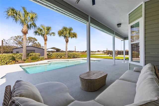 outdoor pool with a patio area and outdoor lounge area