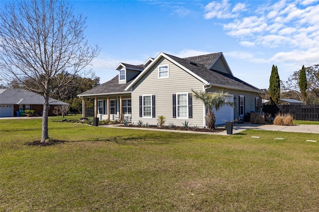 view of front facade featuring a garage, fence, driveway, and a front lawn