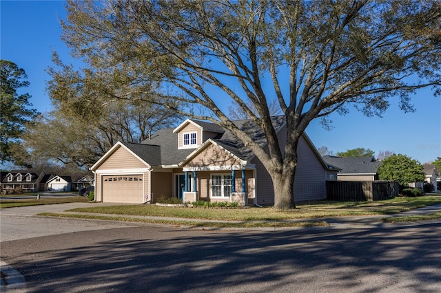 view of front of home with concrete driveway, roof with shingles, a garage, and fence